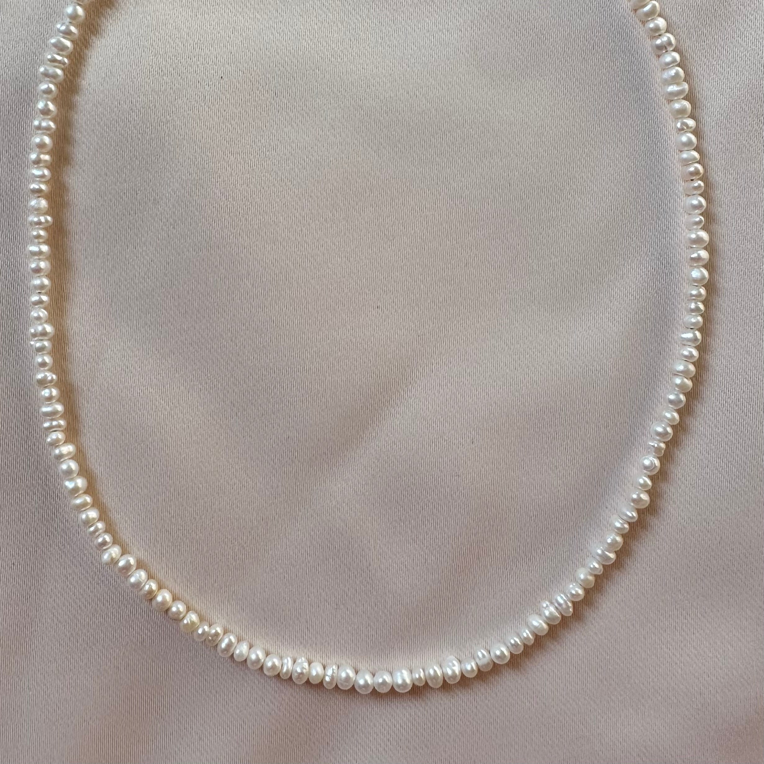 Pearl necklace on a light background