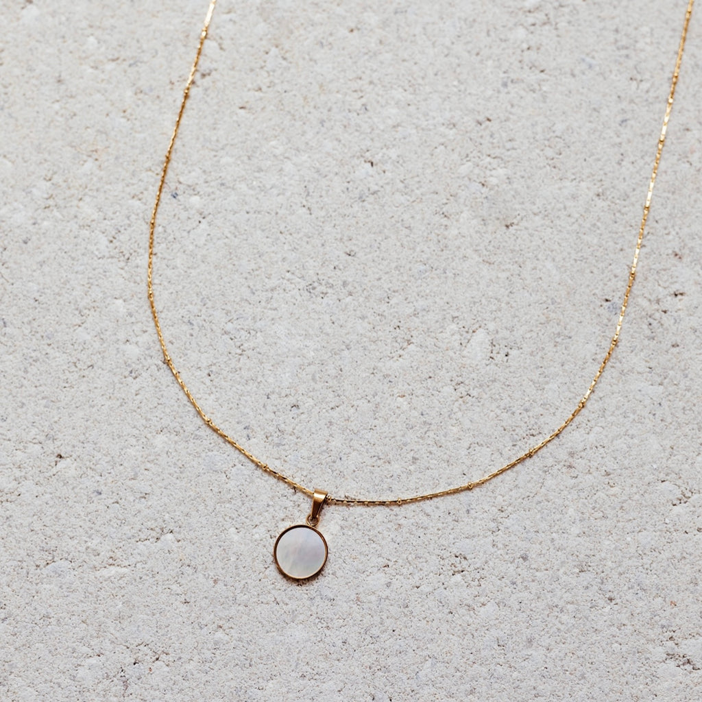 stainless steel ora necklace pearled center gold border  Edit alt text
