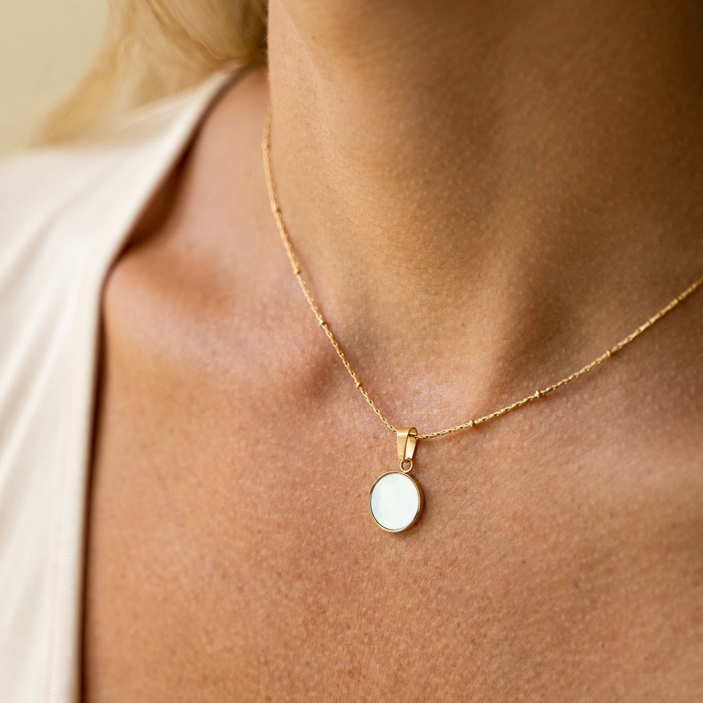 stainless steel ora necklace pearled center gold border